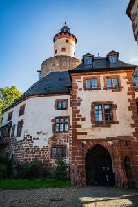 a building with a lighthouse on top of it at Hotel Schloss Büdingen in Büdingen