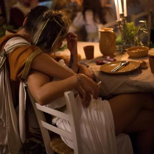 a woman sitting on a chair at a table at Castello di Baccaresca in Branca