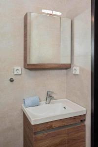 a bathroom with a white sink and a mirror at Condo next to metro st Athens! in Athens