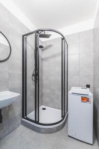 a shower in a bathroom with a sink at BP Hostel / Urbinská 144 in Český Krumlov