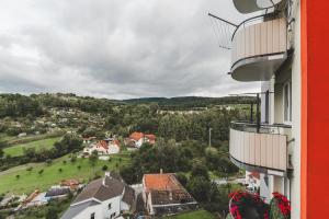 a view of a town from a balcony of a building at BP Hostel / Urbinská 144 in Český Krumlov