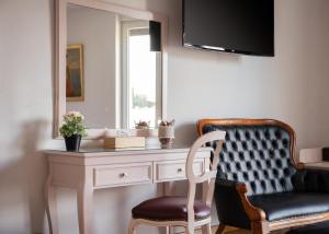 a room with a desk with a chair and a mirror at Acropolis Elegant Penthouse in Athens