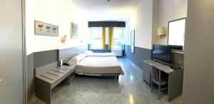Giường trong phòng chung tại Hotel Vitruvio