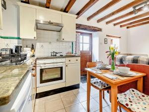 a kitchen with a table and a stove top oven at 1 Bed in Wirksworth PK925 in Wirksworth