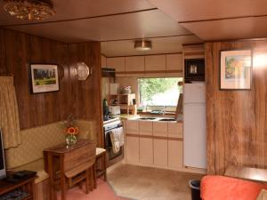 a kitchen with wood paneling and a table in a kitchen at 1 Bed in Bodiam 51574 in Bodiam