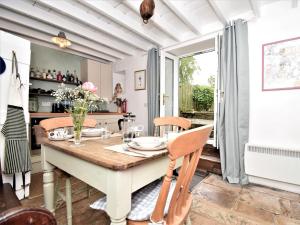 a dining room with a table and chairs and a kitchen at 2 bed in Frosterley 54143 in Frosterley