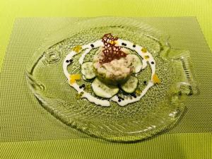 a plate of food with cucumbers and sauce on a table at Genusshotel Gersbacher Hof in Todtmoos