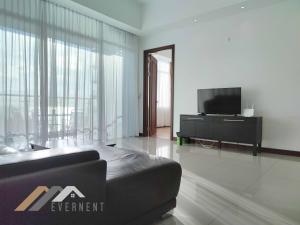 a living room with a tv and a couch at Bay Resort by Evernent in Miri