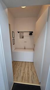 a small bathroom with a tub and a sink at Fewo am premium Wanderort in Bad Berleburg