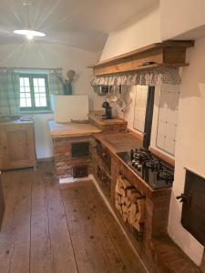 a kitchen with a stove and a counter top at La Baita di Aclete in Tarvisio
