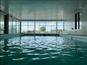a large pool of water in a large building at Piscine, vue, terrasse in Knokke-Heist