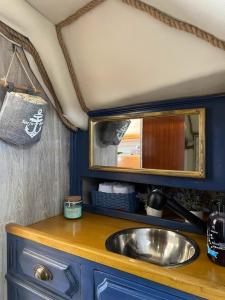 eine Küche mit einem Waschbecken und einem Spiegel in der Unterkunft Morgane in Vila Nova de Gaia