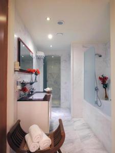 a bathroom with a sink and a bath tub at Out Of The Blue Resort & Spa in Agia Pelagia