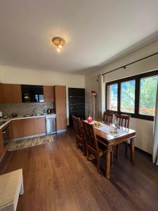 a kitchen and dining room with a table and chairs at Mountain House Eptalofos in Eptalofos