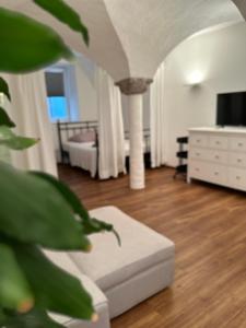 a living room with a couch and a tv in a room at Beautiful Studio in the Heart of Salzburg in Salzburg