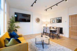 a living room with a yellow couch and a table at The Withington in Manchester