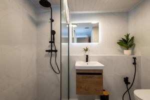 a bathroom with a shower and a sink and a mirror at The Withington in Manchester