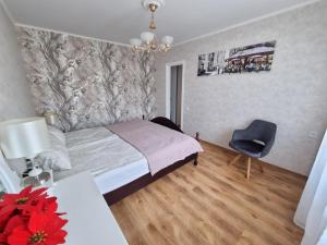 a bedroom with a bed and a desk and a chair at Riga City 2 Bedroom Lux Apartments in Rīga