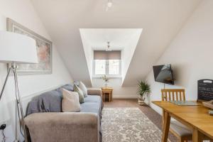 a living room with a couch and a table at Seafront flat-private parking-short walk to town in Weston-super-Mare