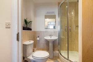 a bathroom with a toilet and a shower and a sink at Seafront flat- Private parking- Close to town in Weston-super-Mare