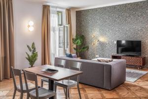 a living room with a couch and a table at Golden Angel Suites by Adrez in Prague