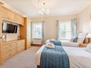 a bedroom with two beds and a flat screen tv at 2 Bed in Alnwick CN218 in Alnwick