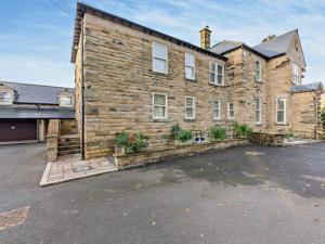 a large brick building with plants in a parking lot at 2 Bed in Alnwick CN218 in Alnwick