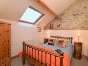 a bedroom with a bed and a skylight at 2 Bed in Godshill IC129 in Godshill