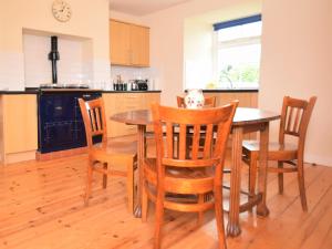 a kitchen with a dining room table and chairs at 2 Bed in Ripon HH039 in Bishop Monkton
