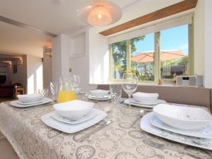 a dining room table with glasses and dishes on it at 3 Bed in Winkleigh 66043 in Winkleigh