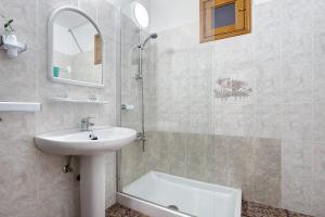 a bathroom with a sink and a shower with a mirror at Casa la solapa in Pájara +20 photos