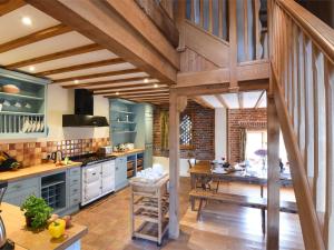 a kitchen with blue cabinets and a wooden floor at 3 Bed in Briston KT187 in Briston