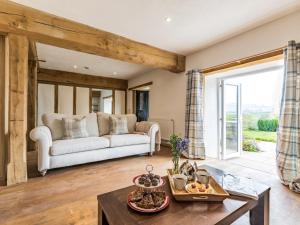 a living room with a couch and a table at 6 Bed in Cadeleigh 66780 in Cadeleigh