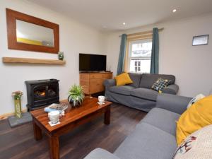 a living room with a couch and a fireplace at 2 Bed in Avoch 73550 in Avoch