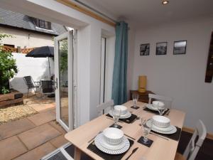 a dining room table with plates and glasses on it at 2 Bed in Avoch 73550 in Avoch