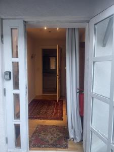 an entrance to a room with a door and a hallway at Oberneulander Gästehaus in Bremen