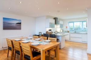 a kitchen and dining room with a wooden table and chairs at Carbis Bay and Spa Hotel in St Ives