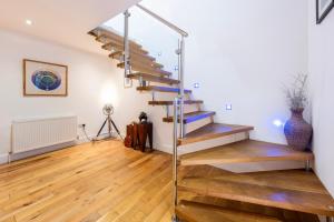 a staircase in a living room with wooden floors at Carbis Bay and Spa Hotel in St Ives