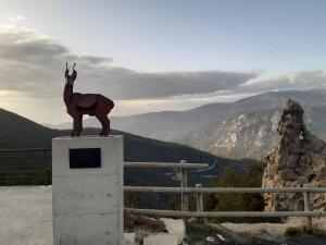 a statue of a horse standing on top of a box at Coll de Port in Tuixen
