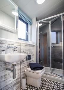 a bathroom with a sink and a toilet and a shower at Sauchope Links Holiday Lodge and Glamping Park in Crail