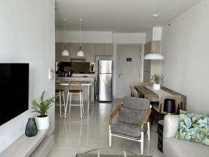 a kitchen and living room with a couch and a table at 2 bedroom Condo at Cassia Laguna in Bang Tao Beach