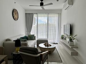 a living room with a couch and a table at 2 bedroom Condo at Cassia Laguna in Bang Tao Beach