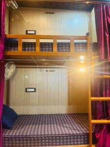 a room with two bunk beds in a room at Maa Gayatri Dormitory in Varanasi