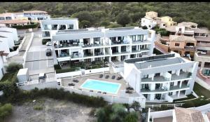 an aerial view of a building with a swimming pool at Resort Le Maree Cannigione in Cannigione