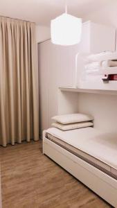 a white room with a bed and a window at Resort Le Maree Cannigione in Cannigione +24 photos