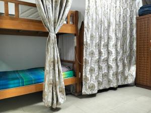 a bunk bed in a room with a curtain at Executive Becholars Hostel in Dubai