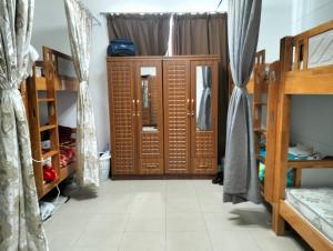 a room with two bunk beds and a doorway at Executive Becholars Hostel in Dubai