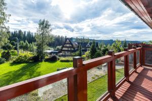 a wooden balcony with a view of a yard at Bukowina Tatrzańska Apartamenty- Tatrzańska 35 blisko termy Bukovina in Bukowina Tatrzańska