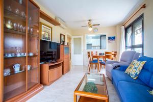 a living room with a blue couch and a table at ESPACIO 3 - Primera Línea de Playa in Cullera +82 photos