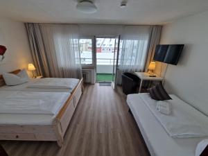 Postel nebo postele na pokoji v ubytování Apart Hotel Freiburg